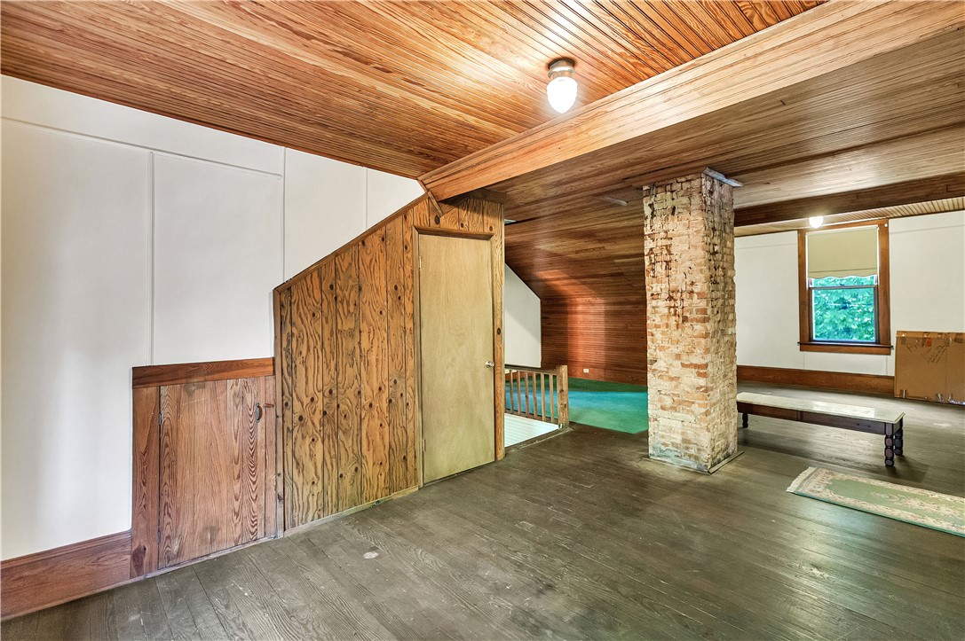 205 West Mauldin Street Walhalla, SC 29691 - Photo 22 of 43 Natural wood finishes and rustic brick accents define this adaptable upper-level space.
