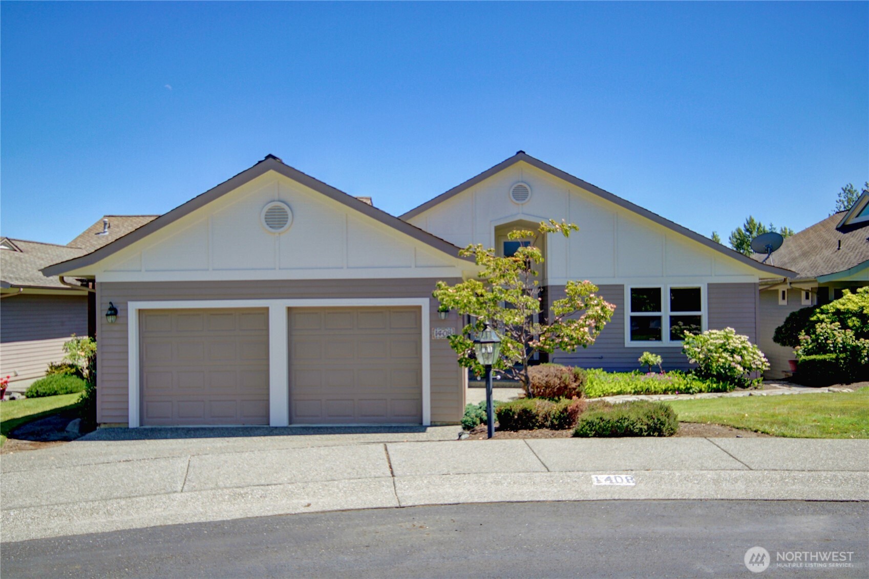 1408 Alpine View Place, Unit 2D Mount Vernon, WA 98274 - Photo 3 of 40 a front view of a house with a yard and garage