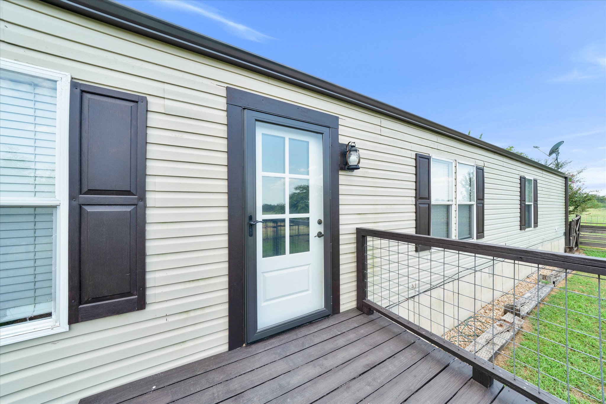 1500 Wattsville Road Luling, TX 78648 - Photo 23 of 38 Guest House - A welcoming front porch with a wood deck and durable vinyl siding provides charming curb appeal.