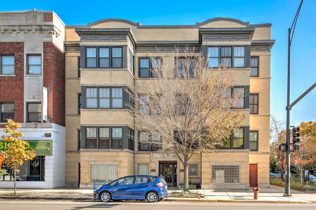 a front view of a residential apartment building with a yard