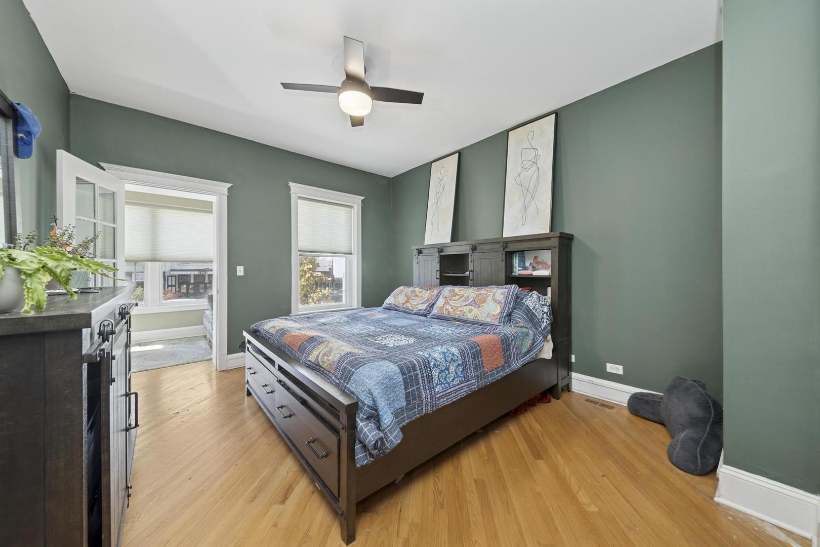 6743 North Sheridan Road, Unit 1N Chicago, IL 60626 - Photo 11 of 26 a bedroom with a bed chandelier and a window