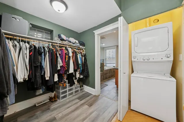 a view of walk in closet with clothes and shoes