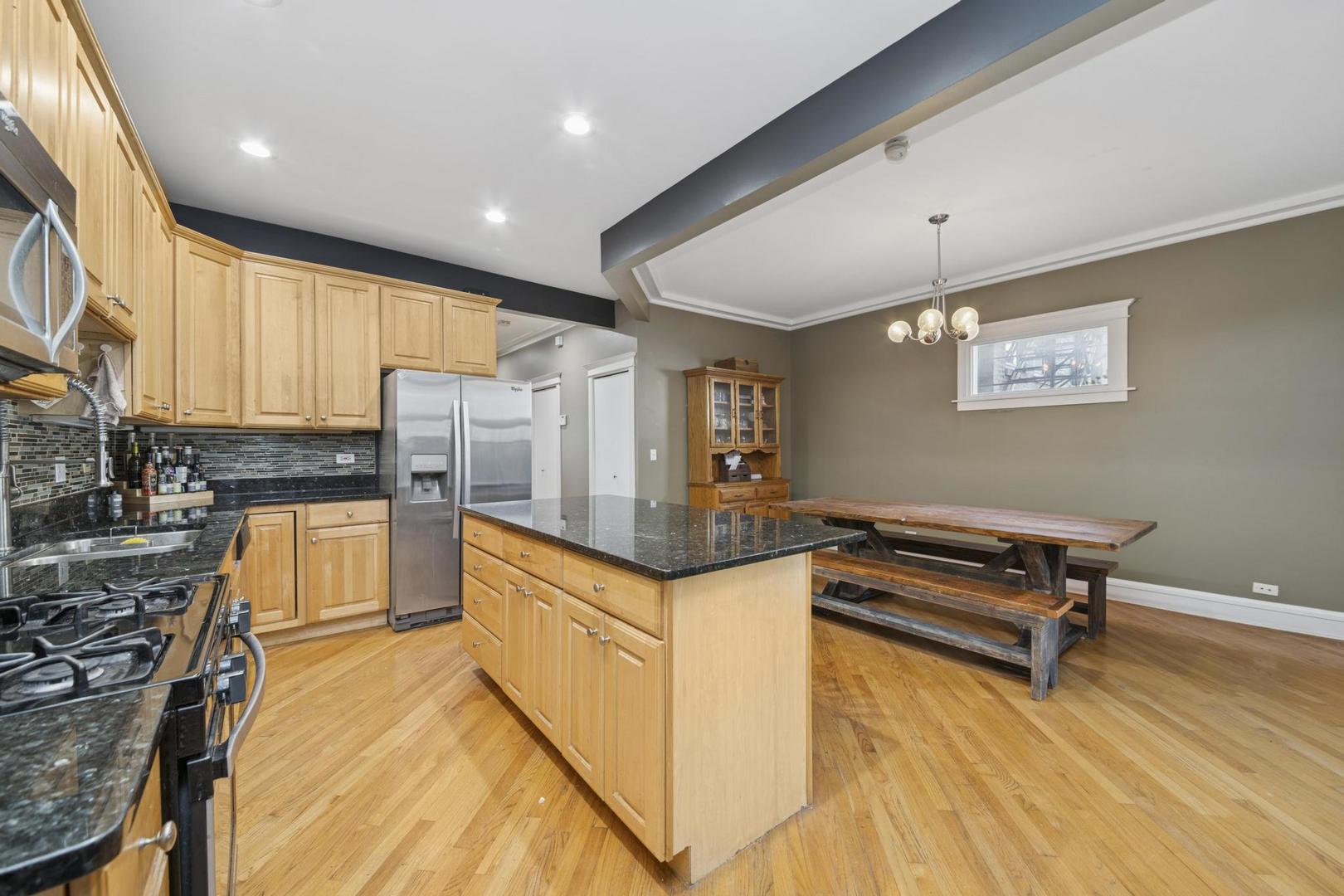 6743 North Sheridan Road, Unit 1N Chicago, IL 60626 - Photo 15 of 26 a kitchen with stainless steel appliances granite countertop a stove a sink and a refrigerator