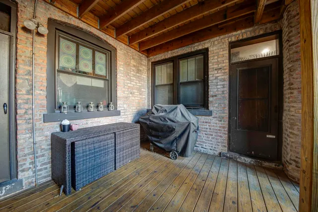 a living room with a couch wooden floor and a table
