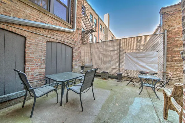 a view of a patio with table and chairs and potted plants