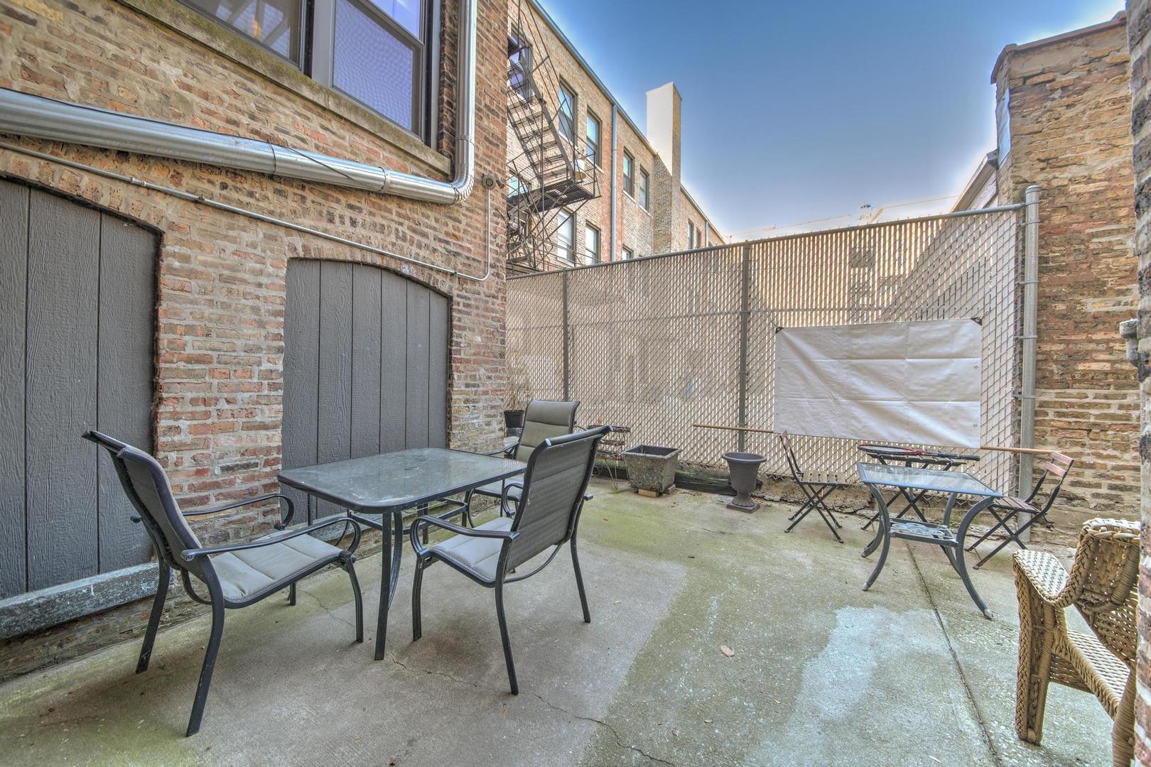 6743 North Sheridan Road, Unit 1N Chicago, IL 60626 - Photo 26 of 26 a view of a patio with table and chairs and potted plants