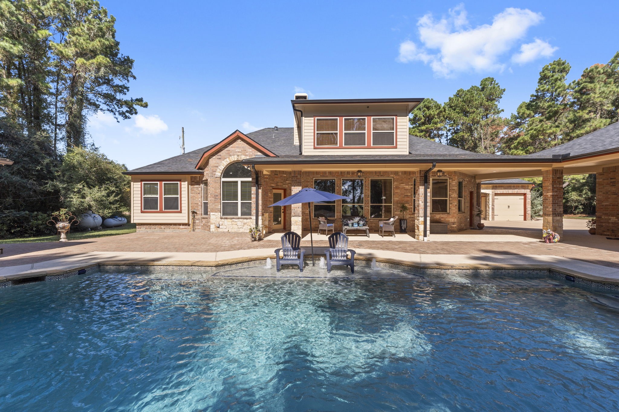 1534 Virgie Community Road Magnolia, TX 77354 - Photo 35 of 50 The large covered back patio provides plenty of shade for lounging or dining outdoors, creating the perfect spot to unwind or entertain by the pool.