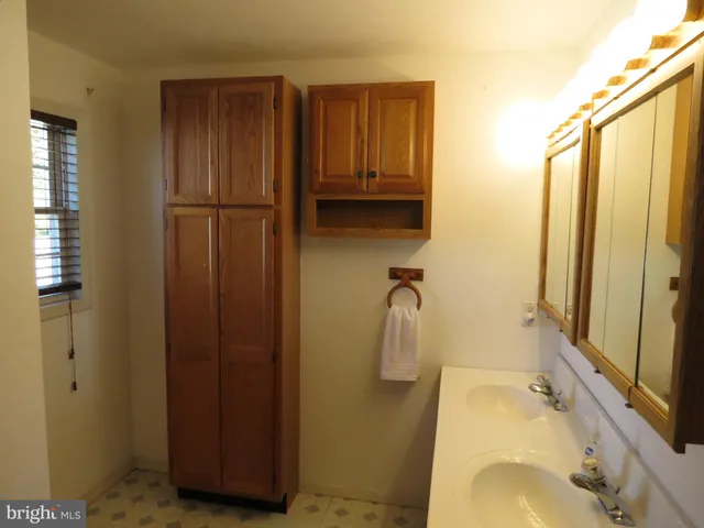 a bathroom with a sink a mirror and shower