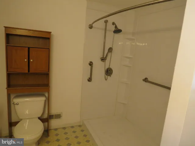 a bathroom with a glass door shower