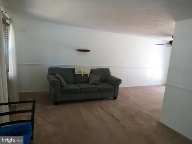 a living room with furniture and a walk in closet