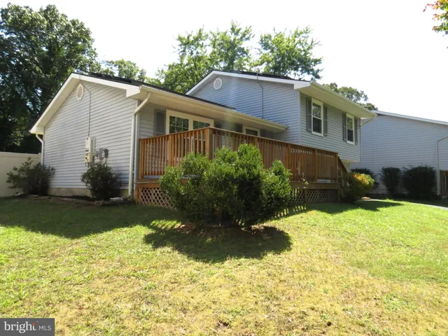 a view of a house with a yard and sitting area