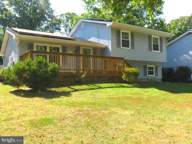 a view of a house with a yard and sitting area