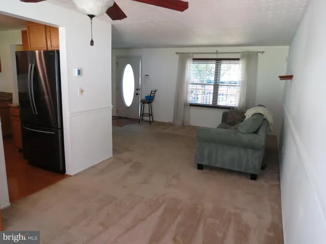 a kitchen with stainless steel appliances granite countertop a refrigerator a microwave a sink and cabinets