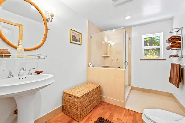 a bathroom with a sink a toilet and a mirror