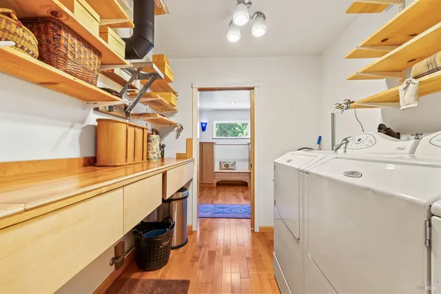 a kitchen with a sink and wooden floor