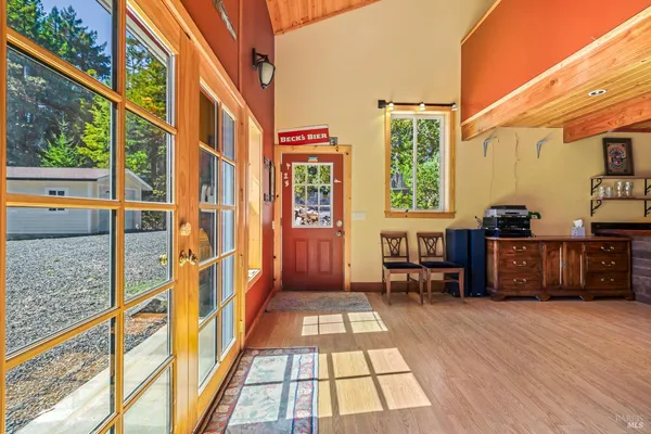 a view of a porch with wooden floor and furniture