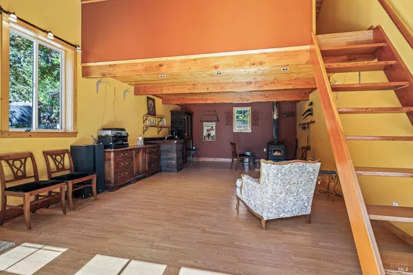 a living room with furniture window and wooden floor
