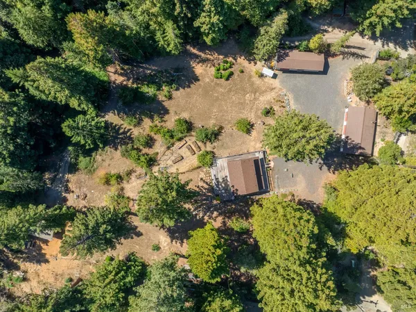 an aerial view of a house with a yard