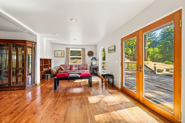 a living room filled with furniture and a wooden floor