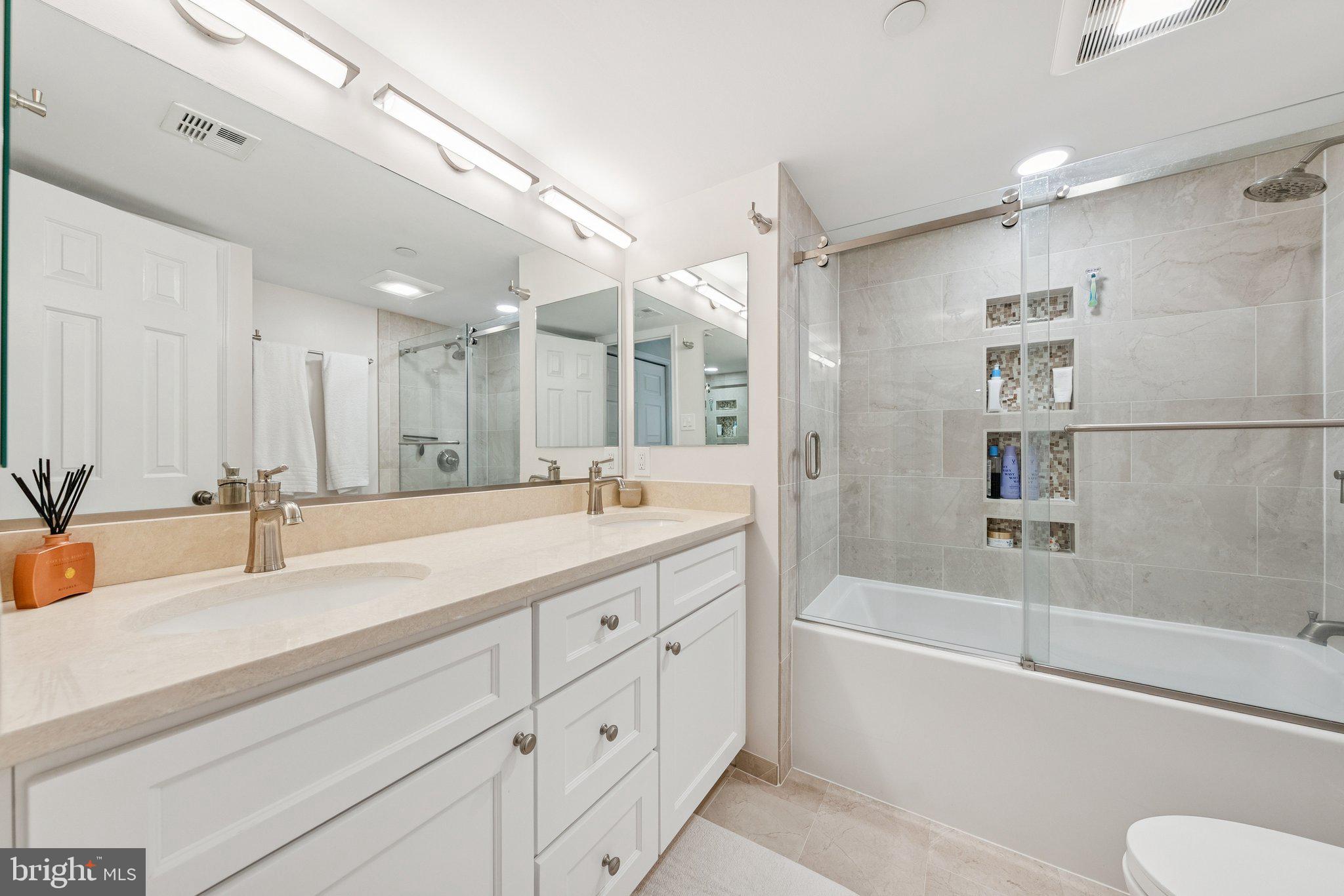 1301 North Courthouse Road, Unit 1810 Arlington, VA 22201 - Photo 16 of 29 a bathroom with a tub sink and mirror