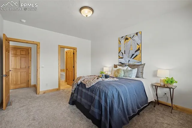 a bedroom with a bed and a painting on the wall