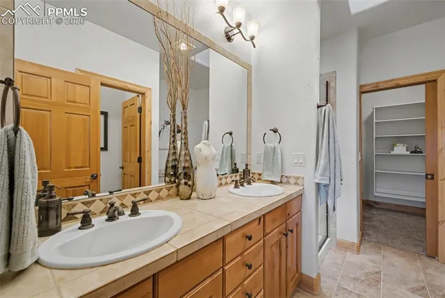 a bathroom with a sink double vanity and a mirror