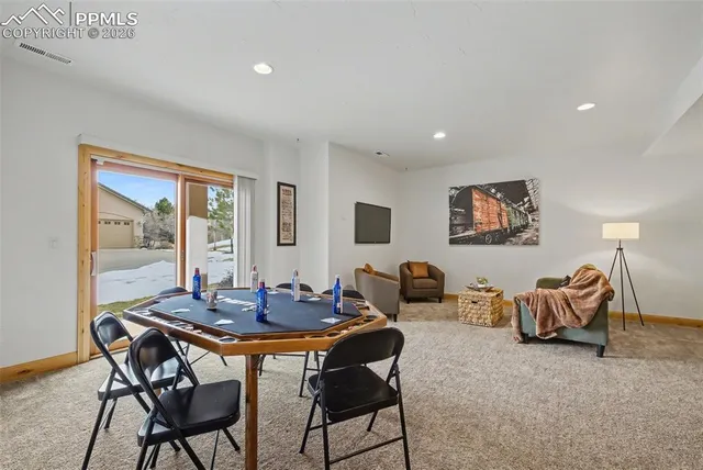 a dining room with furniture and window