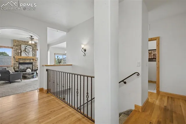 a view of a livingroom with wooden floor and furniture