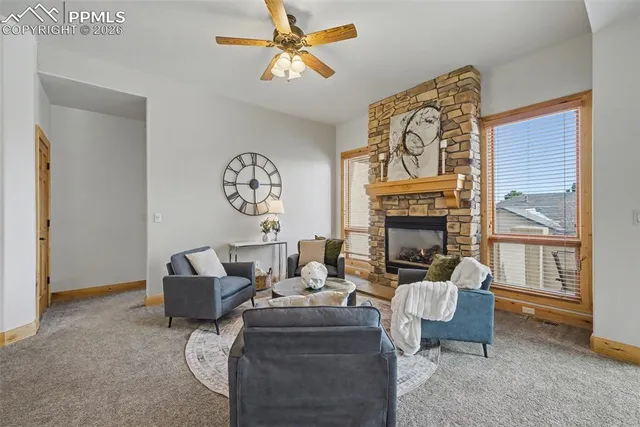 a living room with fireplace furniture and a window