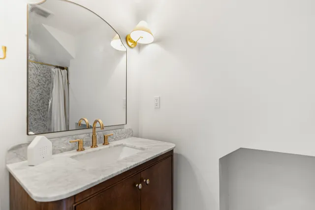 a bathroom with a sink and a mirror