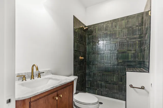 a bathroom with a sink toilet and shower