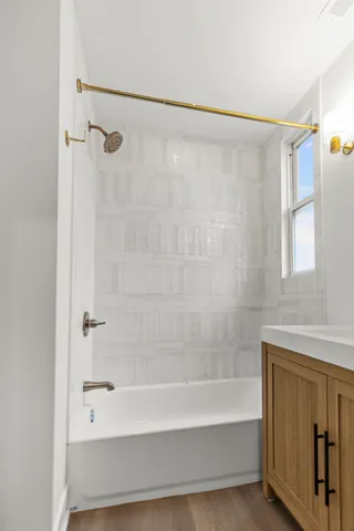 a bathroom with a shower and a bath tub