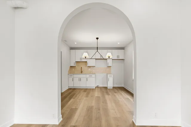a view of a kitchen with wooden floor