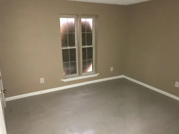 an empty room with a empty space and window