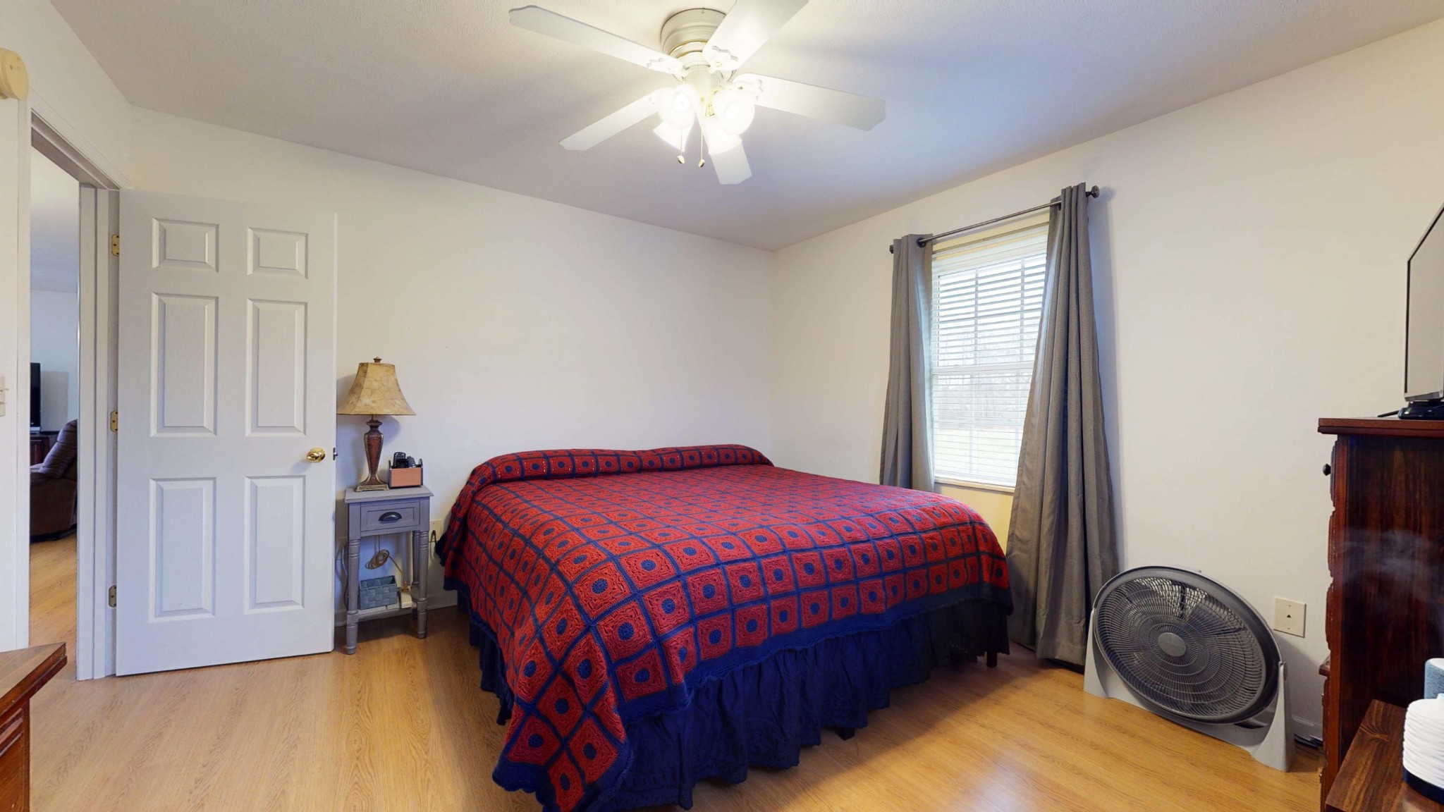 175 Accommodation Road Blaine, TN 37709 - Photo 17 of 30 a bedroom with a bed and a chandelier