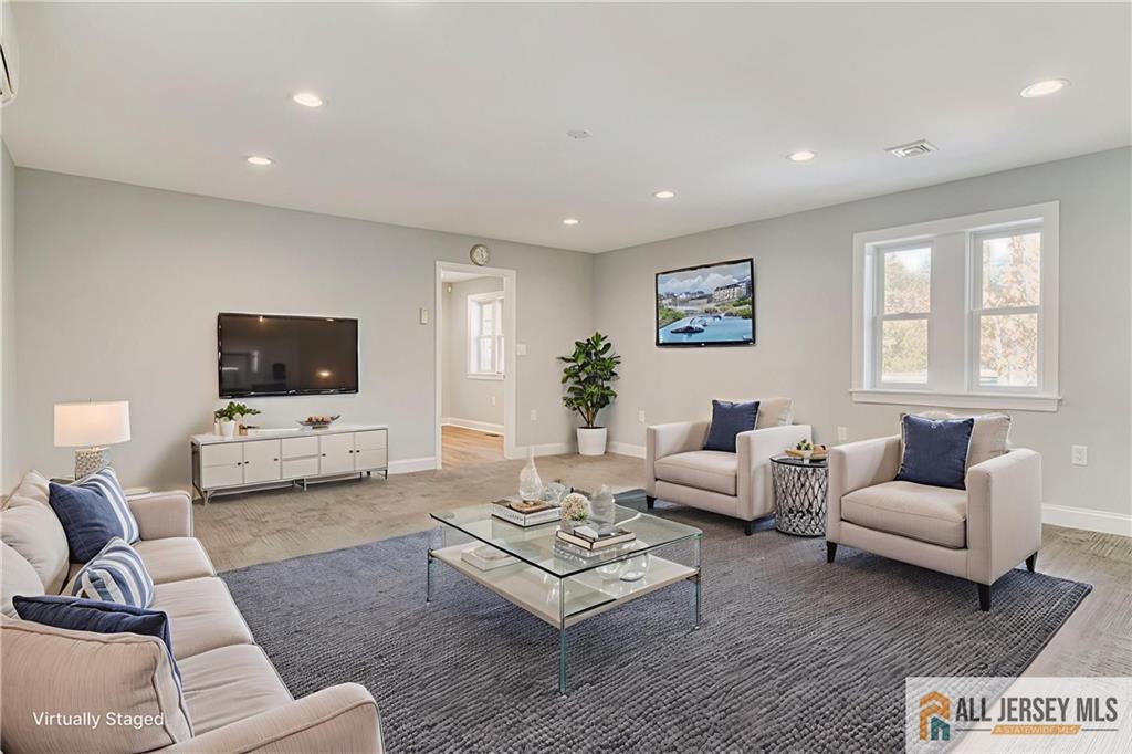 176 Old Forge Road Monroe Township, NJ 08831 - Photo 12 of 36 a living room with furniture and a flat screen tv
