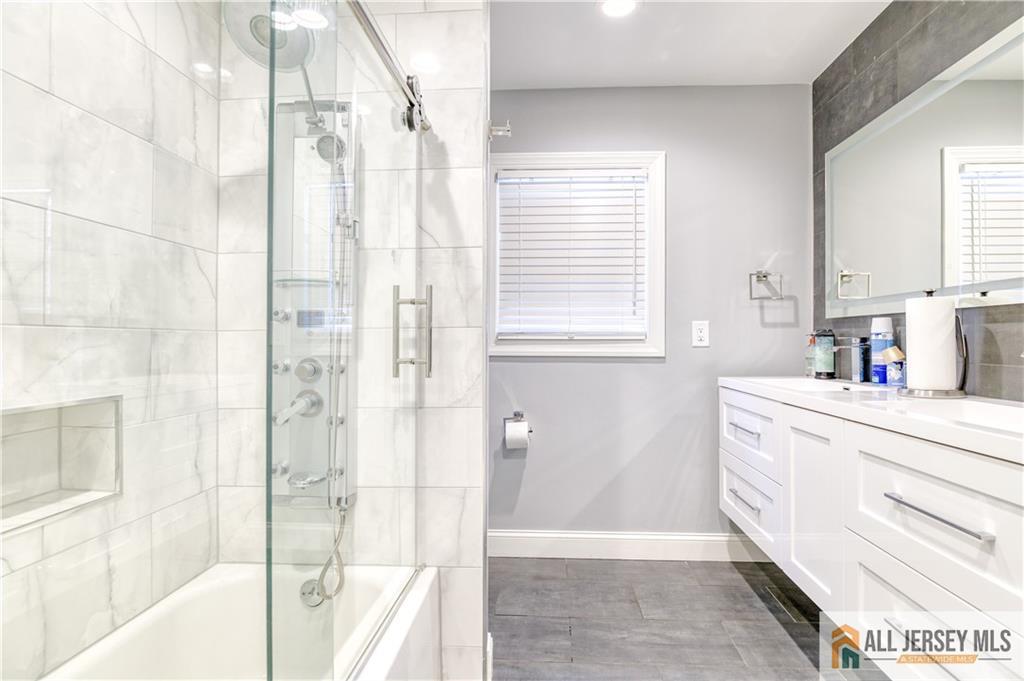 176 Old Forge Road Monroe Township, NJ 08831 - Photo 14 of 36 a bathroom with a tub sink and mirror