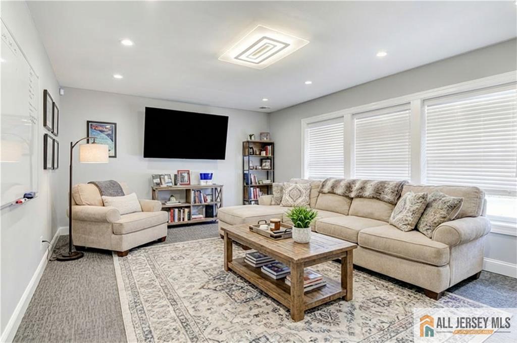 176 Old Forge Road Monroe Township, NJ 08831 - Photo 17 of 36 a living room with furniture and a flat screen tv