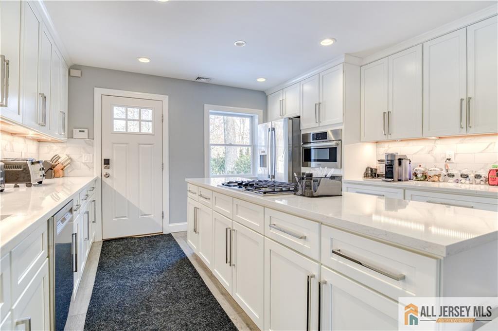 176 Old Forge Road Monroe Township, NJ 08831 - Photo 8 of 36 a kitchen with sink cabinets and window