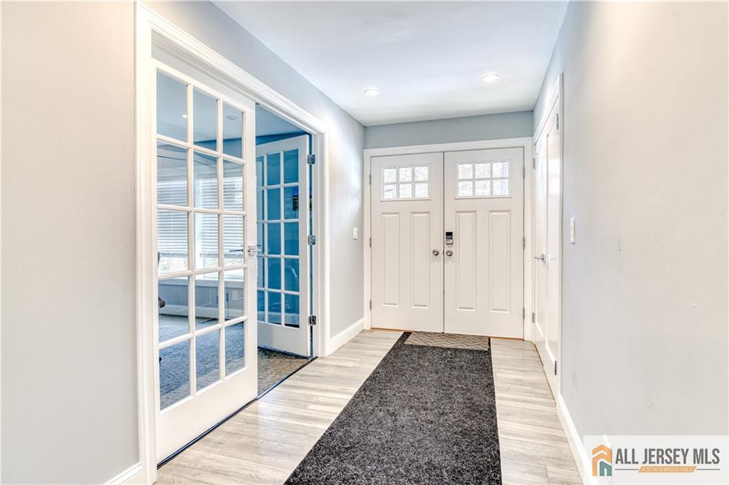 176 Old Forge Road Monroe Township, NJ 08831 - Photo 10 of 36 a view of a hallway with wooden floor and windows