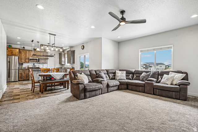 203 North 1900th Street West Mapleton, UT 84664 - Photo 3 of 48 Spacious open-concept living area featuring a large carpeted zone with an overhead ceiling fan, recessed lighting, and a window