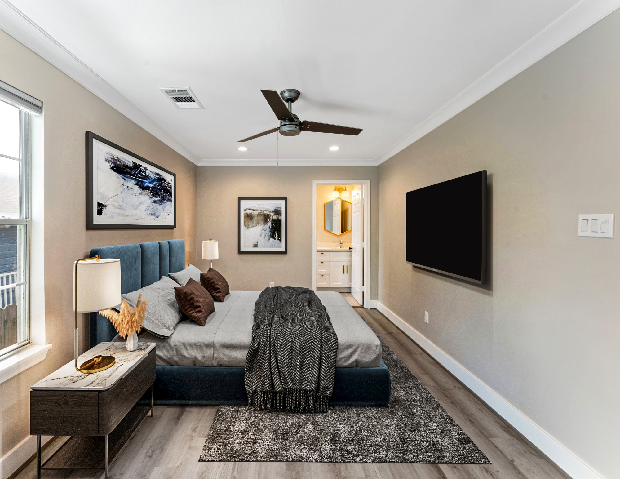 809 East 40th Street Houston, TX 77022 - Photo 15 of 27 Generously sized primary suite featuring updated flooring, fresh paint, and a modern ceiling fan. A relaxing space designed with comfort and simplicity in mind. virtually staged