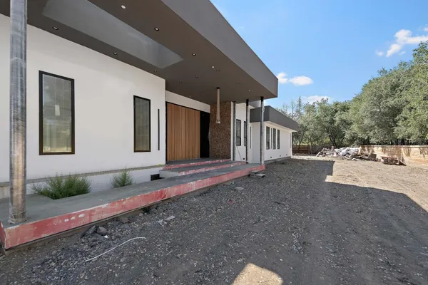 a front view of a house with garden