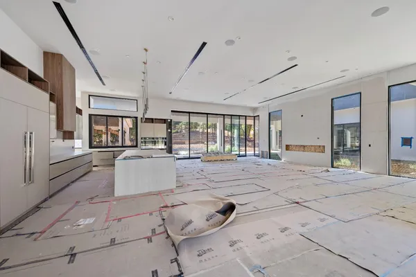 a large white room with lots of white furniture