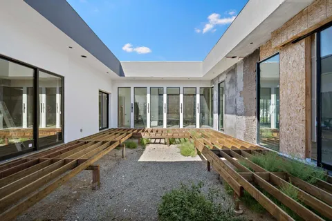 a room with pool table and glass windows