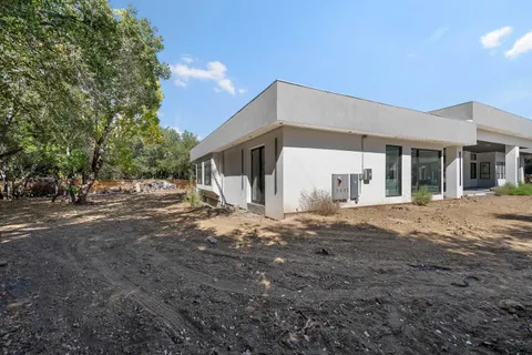 a view of a house with a backyard