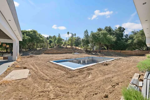 a view of a swimming pool with a yard