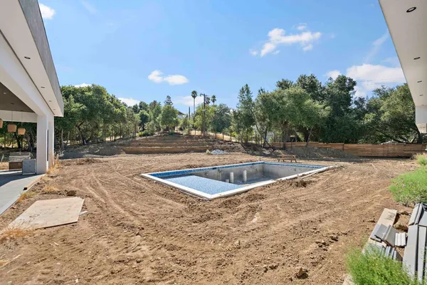 a view of a swimming pool with a yard