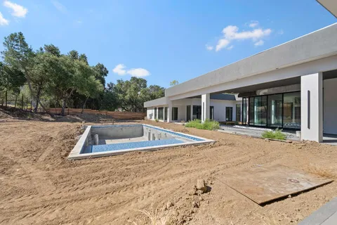 a view of a house with pool and yard