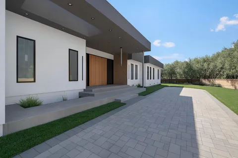 a view of backyard of house with green space